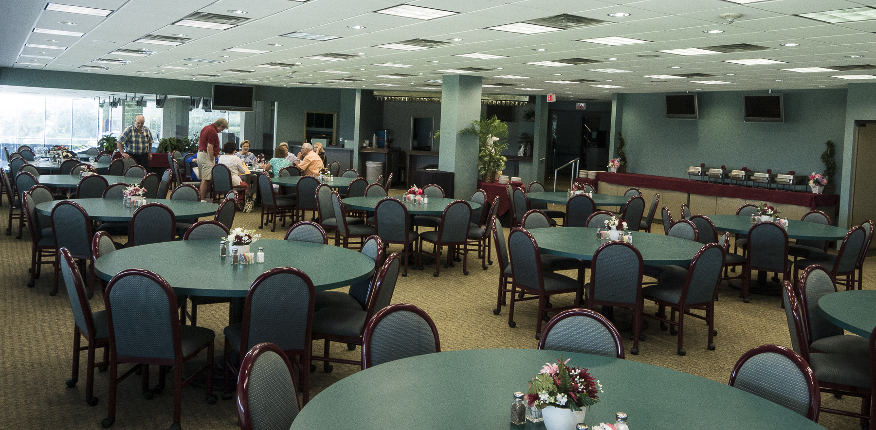 Interior of mezzanine at Orange Park Kennel Club.  Tables will have table cloths and birthday decorations.  Buffet table is on the right rear.